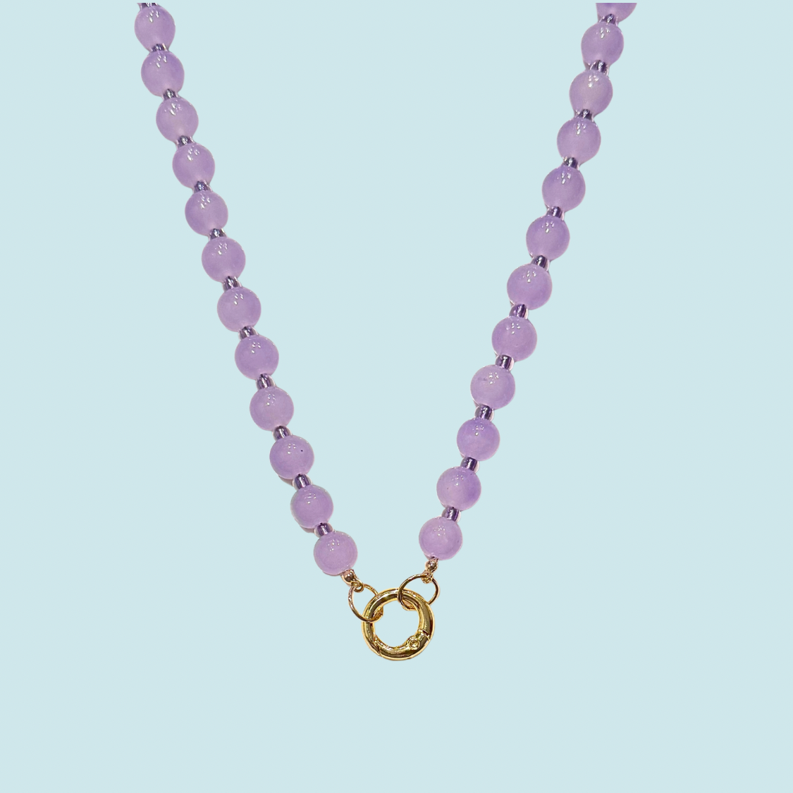 Necklace with purple glass beads and a gold clasp