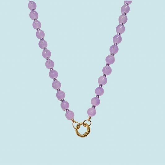 Necklace with purple glass beads and a gold clasp 